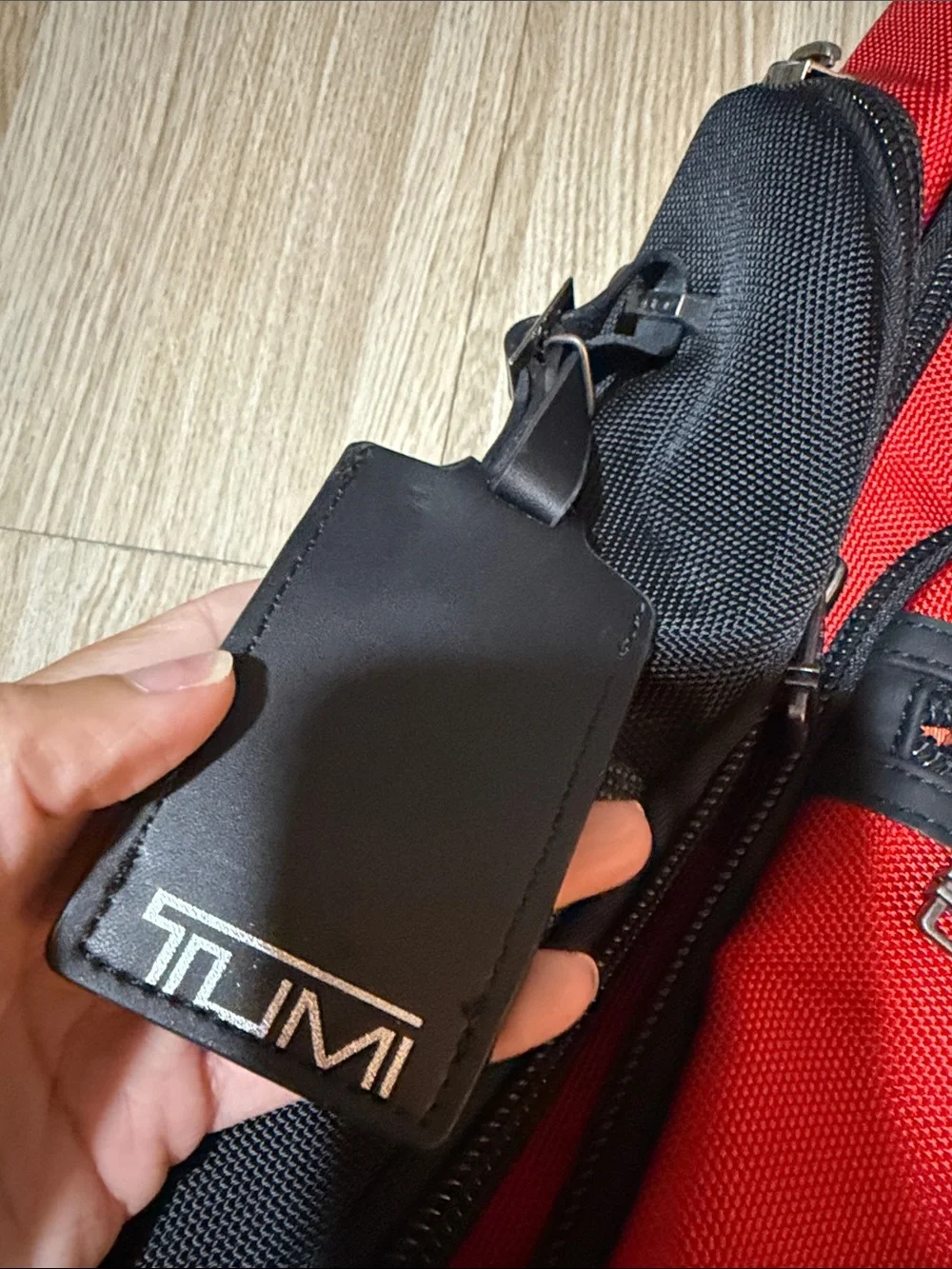 Tumi Red and Black Men/Women’s Backpack with Multiple Front Pockets